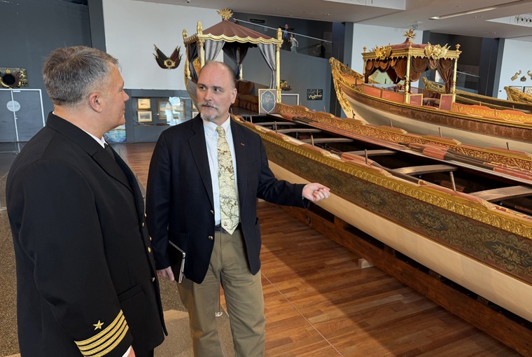 Two men looking at a ship display